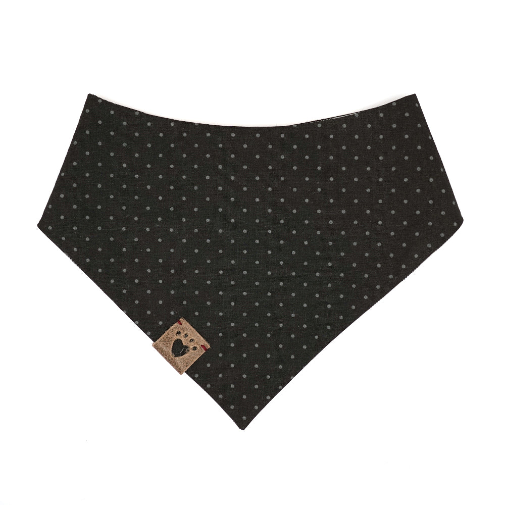 Reversible bandana for dogs. Snaps on back make it adjustable. One side is Black and grey buffalo plaid and the other side has a Black background with dark grey polk-a-dots. Warm Grey tag with heart paw cut out on side.