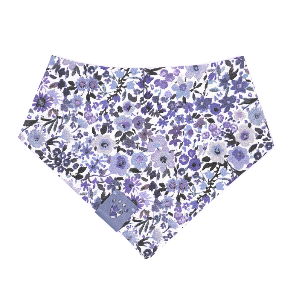 Reversible bandana for dogs. Snaps on back make it adjustable. One side is White background with multiple blue-hued flower and the other side has a Navy blue background with bright blue polka dots. Light Blue tag with heart paw cut out on side.