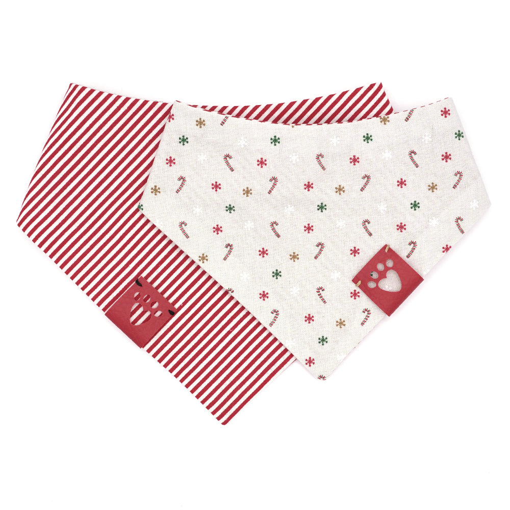 Reversible bandana for dogs. Snaps on back make it adjustable. One side is Light grey (almost white) background with red/white candy canes, and red, green, gold and white snowflakes and the other side has Red and white stripes. Red tag with heart paw cut out on side.