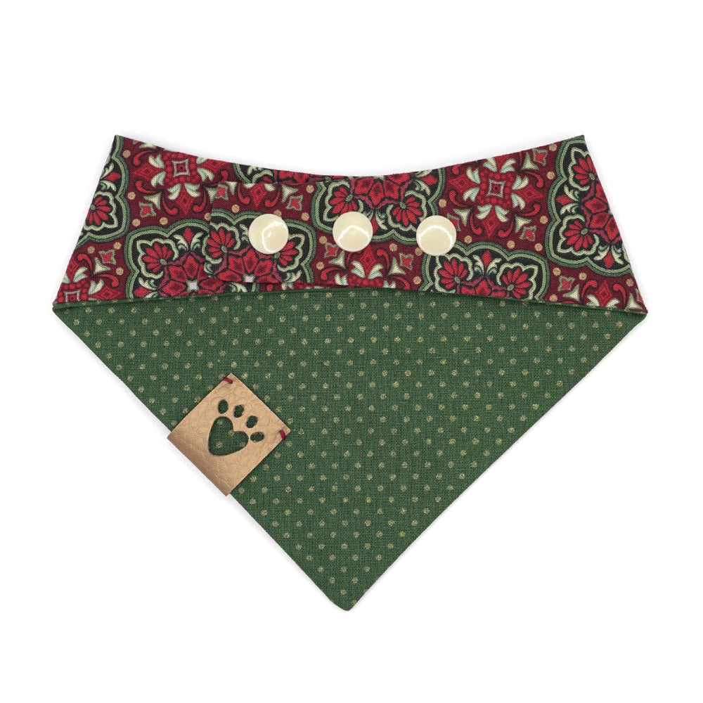 Reversible bandana for dogs. Snaps on back make it adjustable. One side is Red. green, gold and black ornamental design and the other side has a Green background with gold metallic polka dots. Gold tag with heart paw cut out on side.