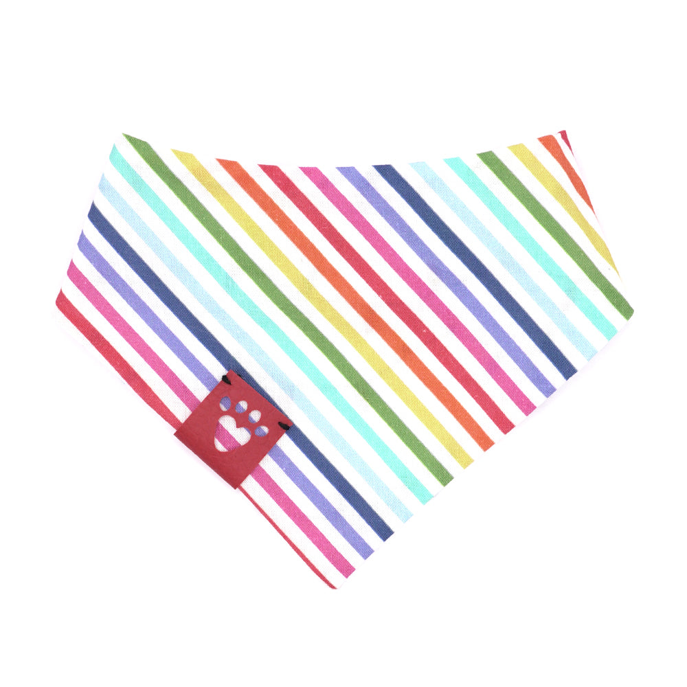 Reversible bandana for dogs. Snaps on back make it adjustable. One side is White background with rainbow-colored lights on a black cord and the other side has a White background with rainbow stripes. Dark Pink tag with heart paw cut out on side.