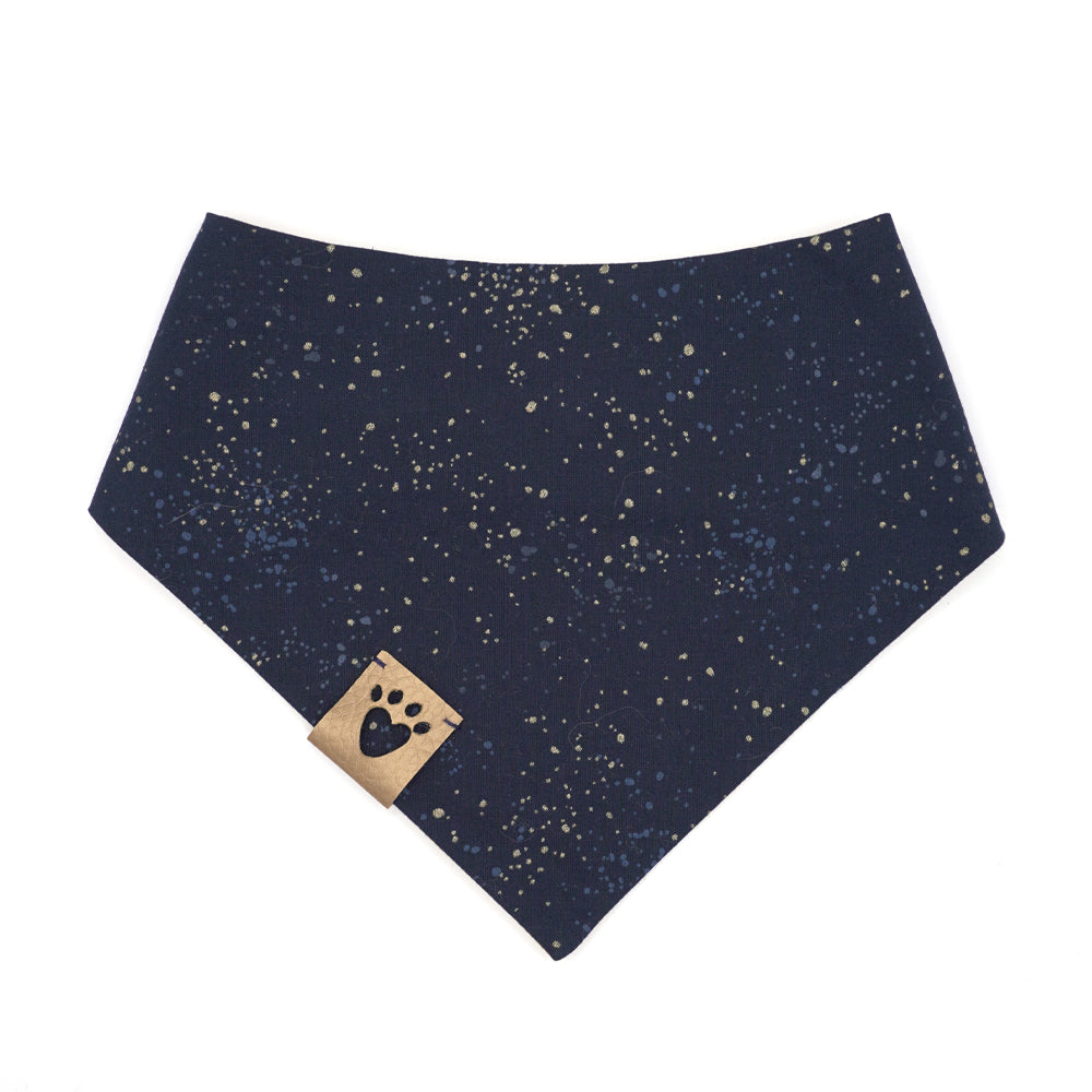 Reversible bandana for dogs. Snaps on back make it adjustable. One side is Mustard yellow background with cream Stars of David and the other side has a Navy blue background with white and yellow "splatter" dots. Metallic gold tag with heart paw cut out on side.