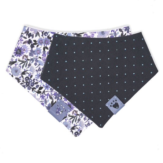 Reversible bandana for dogs. Snaps on back make it adjustable. One side is White background with multiple blue-hued flower and the other side has a Navy blue background with bright blue polka dots. Light Blue tag with heart paw cut out on side.