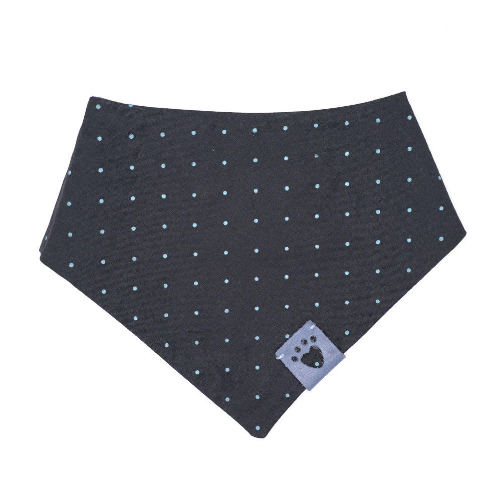 Reversible bandana for dogs. Snaps on back make it adjustable. One side is White background with multiple blue-hued flower and the other side has a Navy blue background with bright blue polka dots. Light Blue tag with heart paw cut out on side.