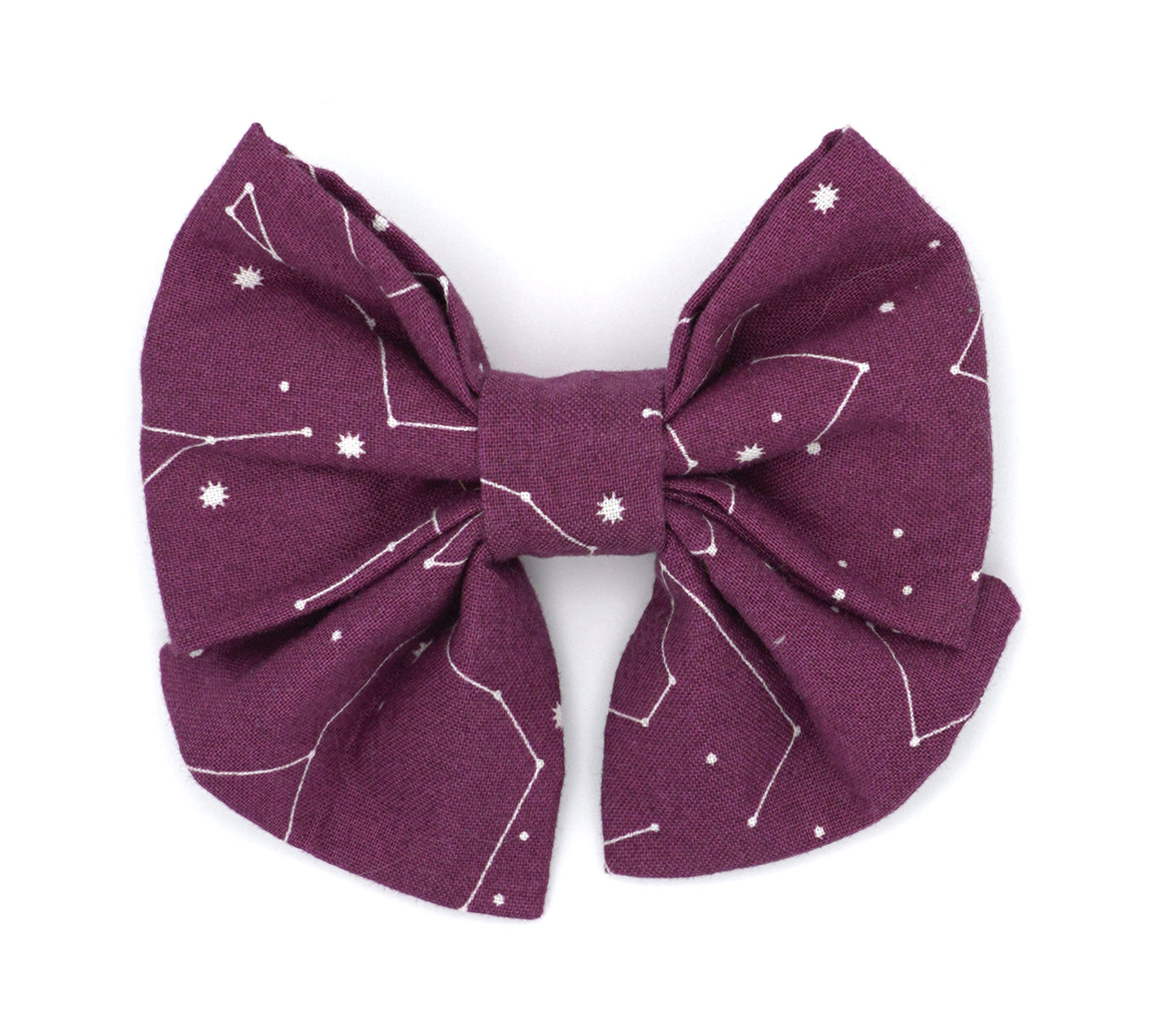 Handmade cotton bow tie with tails for dogs (or other pets). Elastic straps on back with snaps make it easy to add to collar, harness, or leash. Purple/wine color background with white constellations and starbursts