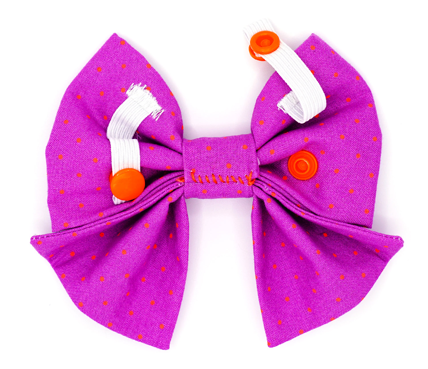 Handmade cotton bow tie with tails for dogs (or other pets). Elastic straps on back with snaps make it easy to add to collar, harness, or leash. Bright purple background with bright orange dots