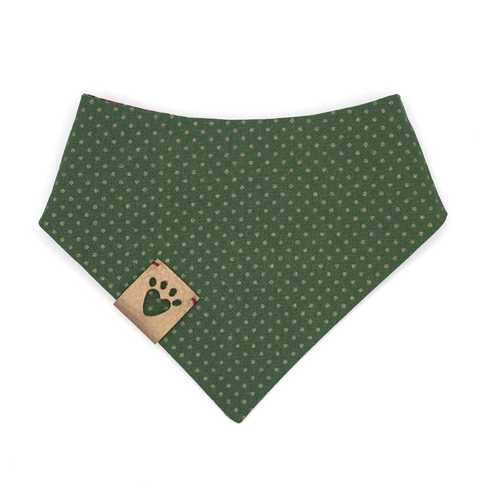 Reversible bandana for dogs. Snaps on back make it adjustable. One side is Red. green, gold and black ornamental design and the other side has a Green background with gold metallic polka dots. Gold tag with heart paw cut out on side.