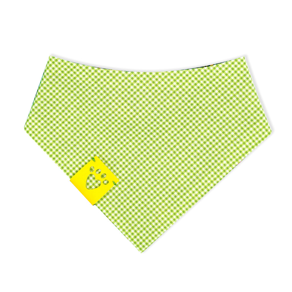 Reversible bandana for dogs. Snaps on back make it adjustable. One side is Dark green/teal background with magenta, dark purple, lime green, white, light blue, goldenrod, and orange flowers and the other side has a Bright lime green and white gingham pattern. Yellow tag with heart paw cut out on side.