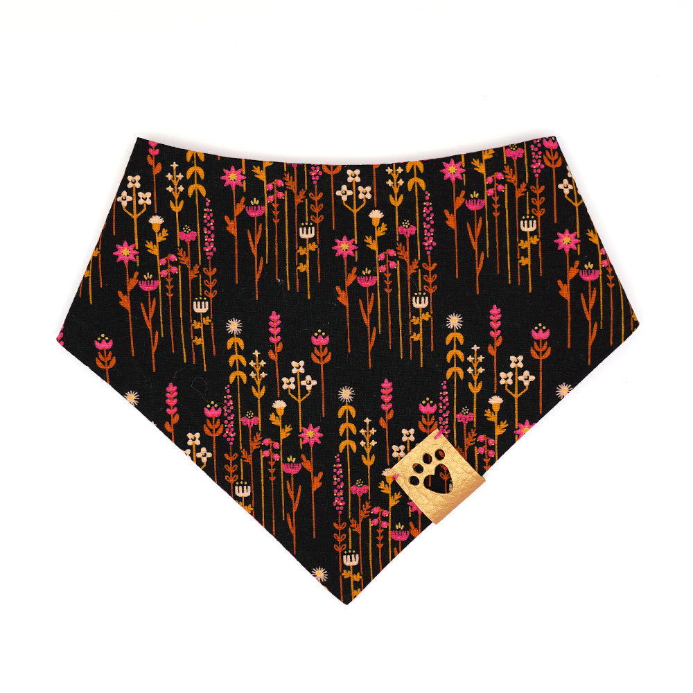 Reversible bandana for dogs. Snaps on back make it adjustable. One side is Hot pink background with light pink and charcoal grey leopard print and the other side has a Black background with hot pink, amber, gold and cream flowers. Metallic gold tag with heart paw cut out on side.