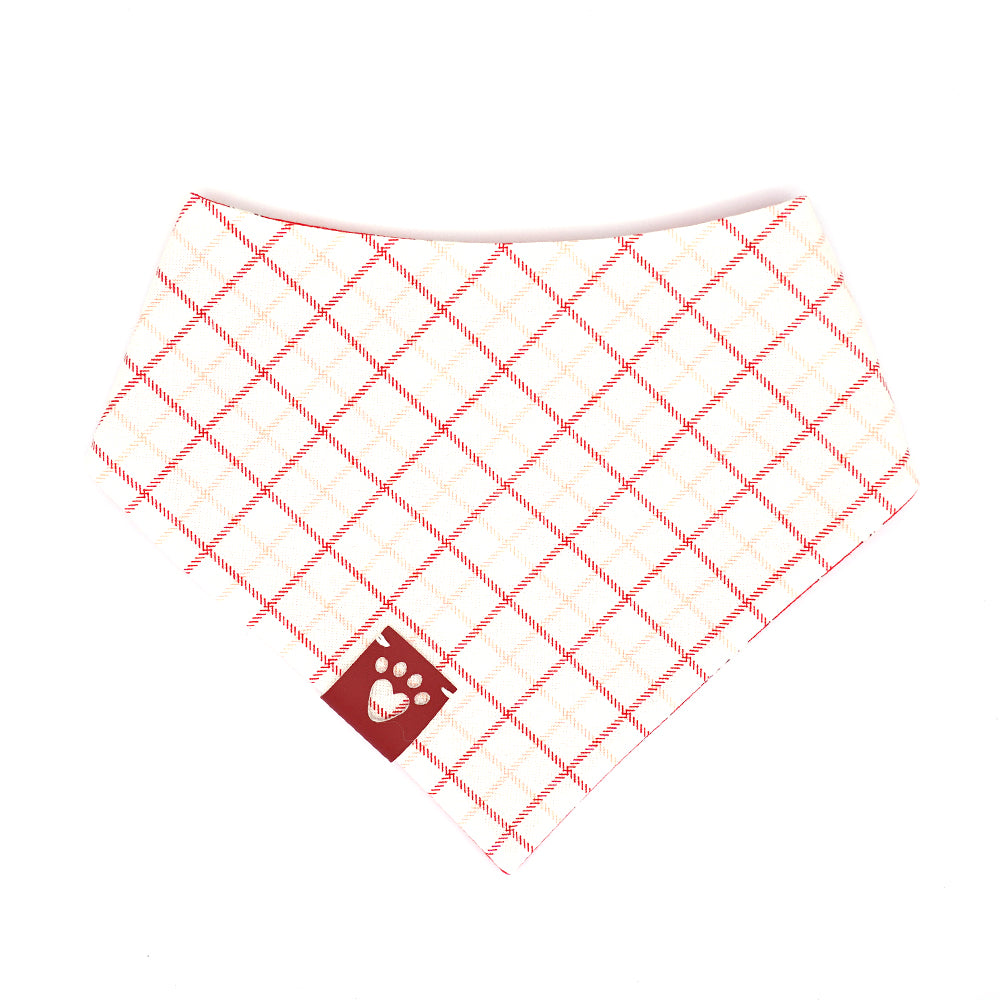 Reversible bandana for dogs. Snaps on back make it adjustable. One side is Bright red background with playful, white, vintage  puppies and the other side has a White background with red and pink line plaid. Dark red tag with heart paw cut out on side.