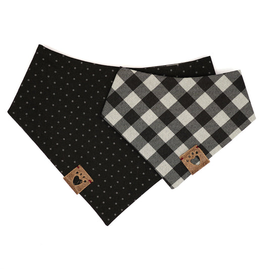 Reversible bandana for dogs. Snaps on back make it adjustable. One side is Black and grey buffalo plaid and the other side has a Black background with dark grey polk-a-dots. Warm Grey tag with heart paw cut out on side.