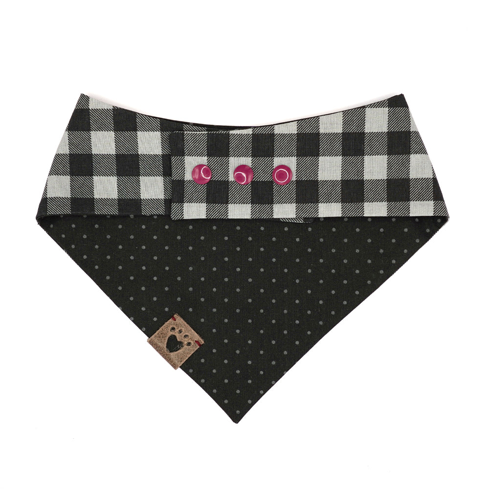 Reversible bandana for dogs. Snaps on back make it adjustable. One side is Black and grey buffalo plaid and the other side has a Black background with dark grey polk-a-dots. Warm Grey tag with heart paw cut out on side.
