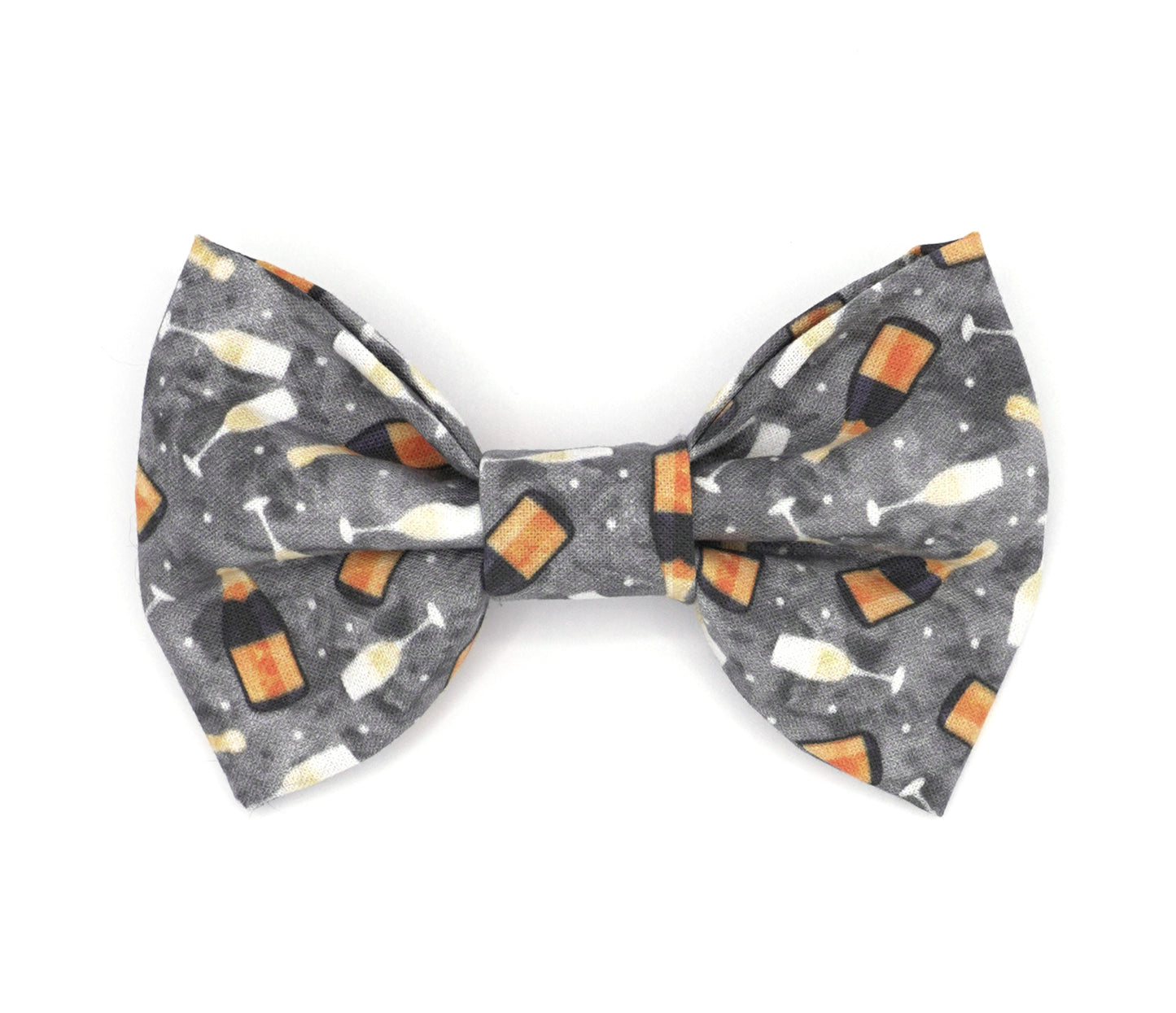 Handmade cotton bow tie for dogs (or other pets). Elastic straps on back with snaps make it easy to add to collar, harness, or leash. Grey background with sparkling wine bottles and glasses.