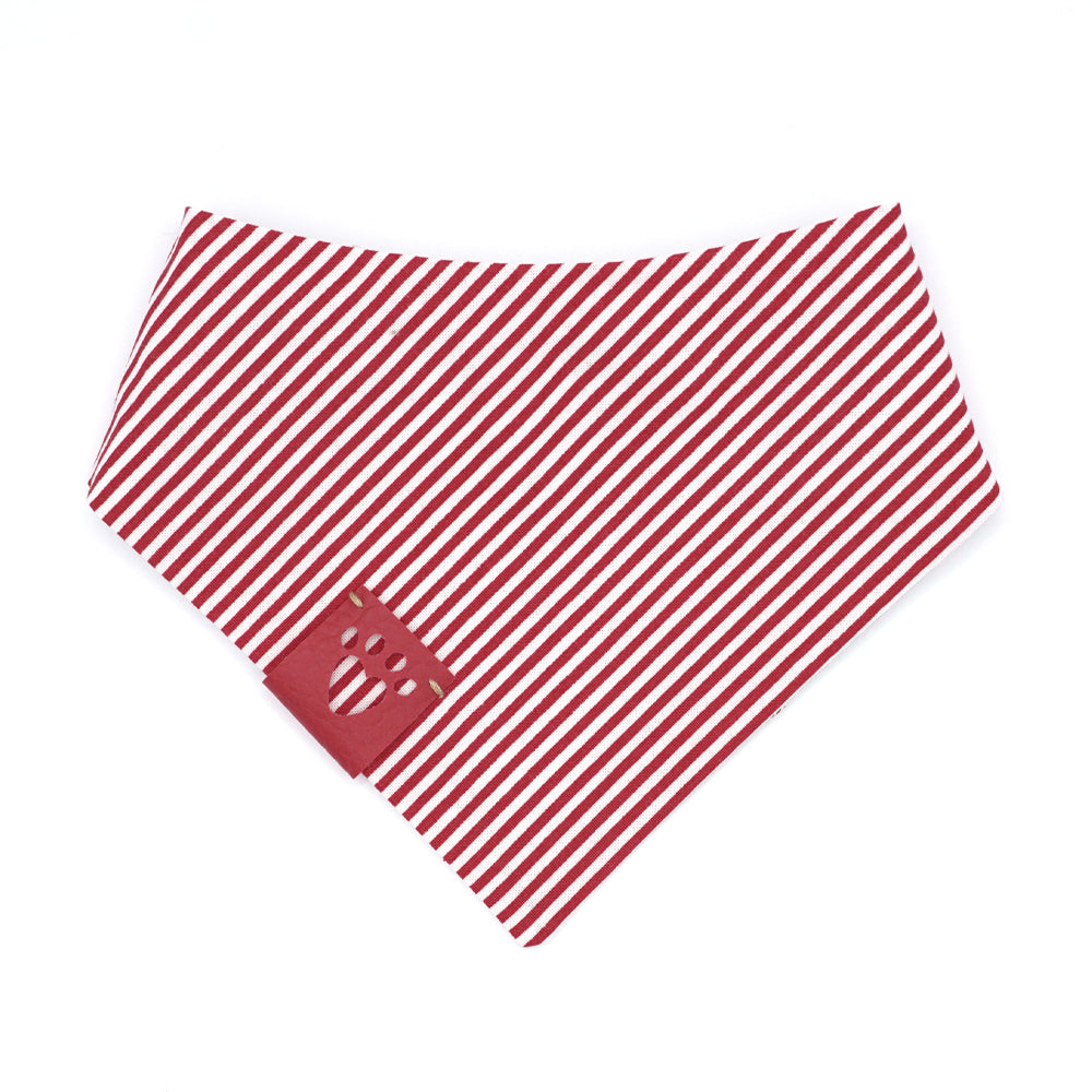  Reversible bandana for dogs. Snaps on back make it adjustable. One side is Light grey (almost white) background with red/white candy canes, and red, green, gold and white snowflakes and the other side has Red and white stripes. Red tag with heart paw cut out on side.