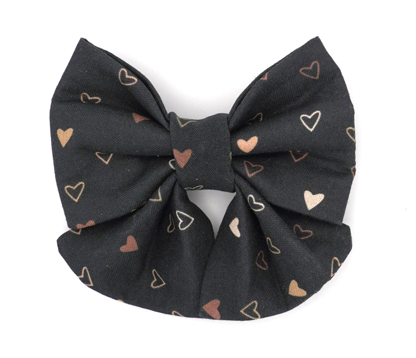 Handmade cotton bow tie with tails for dogs (or other pets). Elastic straps on back with snaps make it easy to add to collar, harness, or leash. Black background with dark and light orange hearts.
