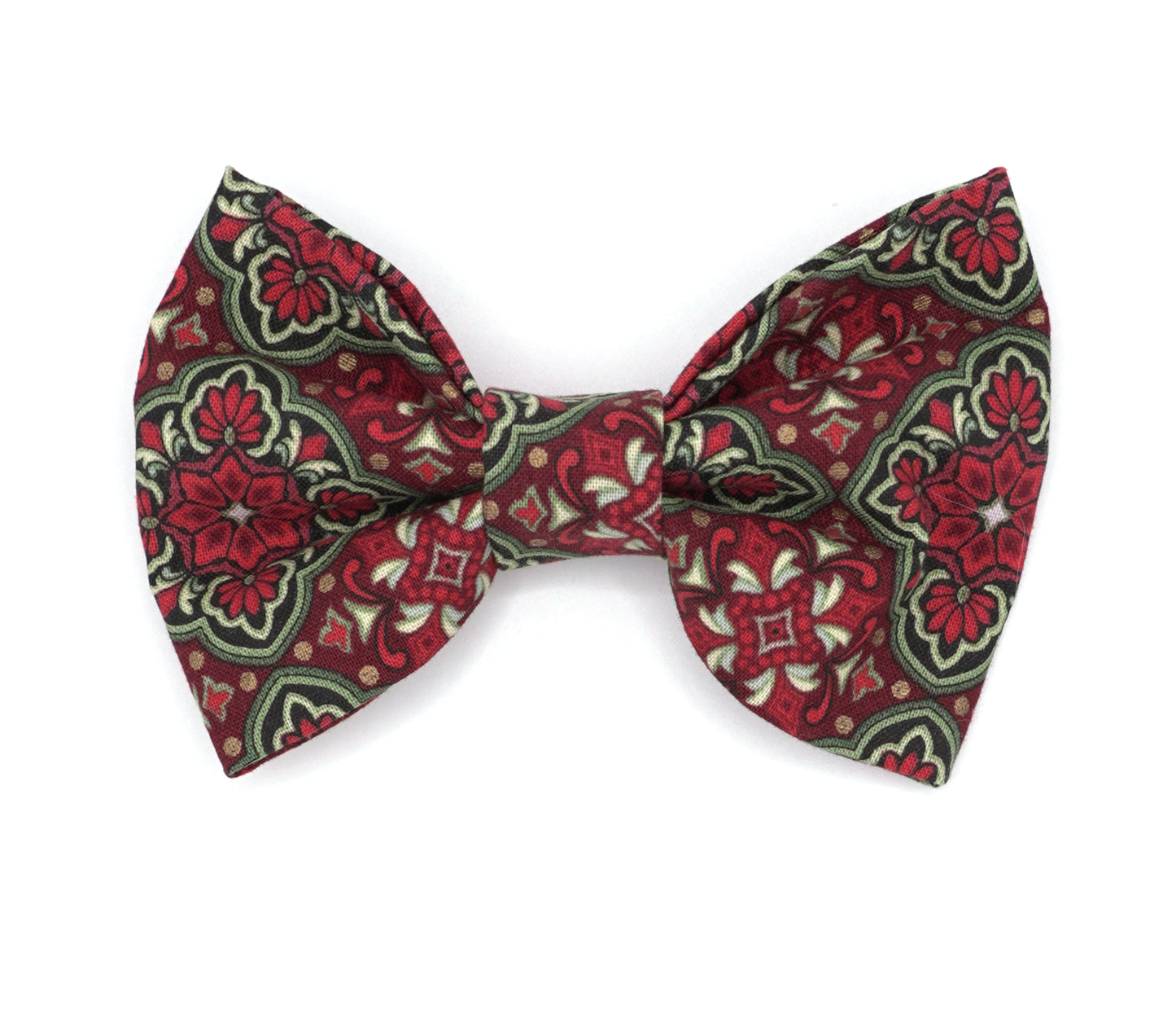 Handmade cotton bow tie for dogs (or other pets). Elastic straps on back with snaps make it easy to add to collar, harness, or leash. Red, green, gold and black ornamental design.