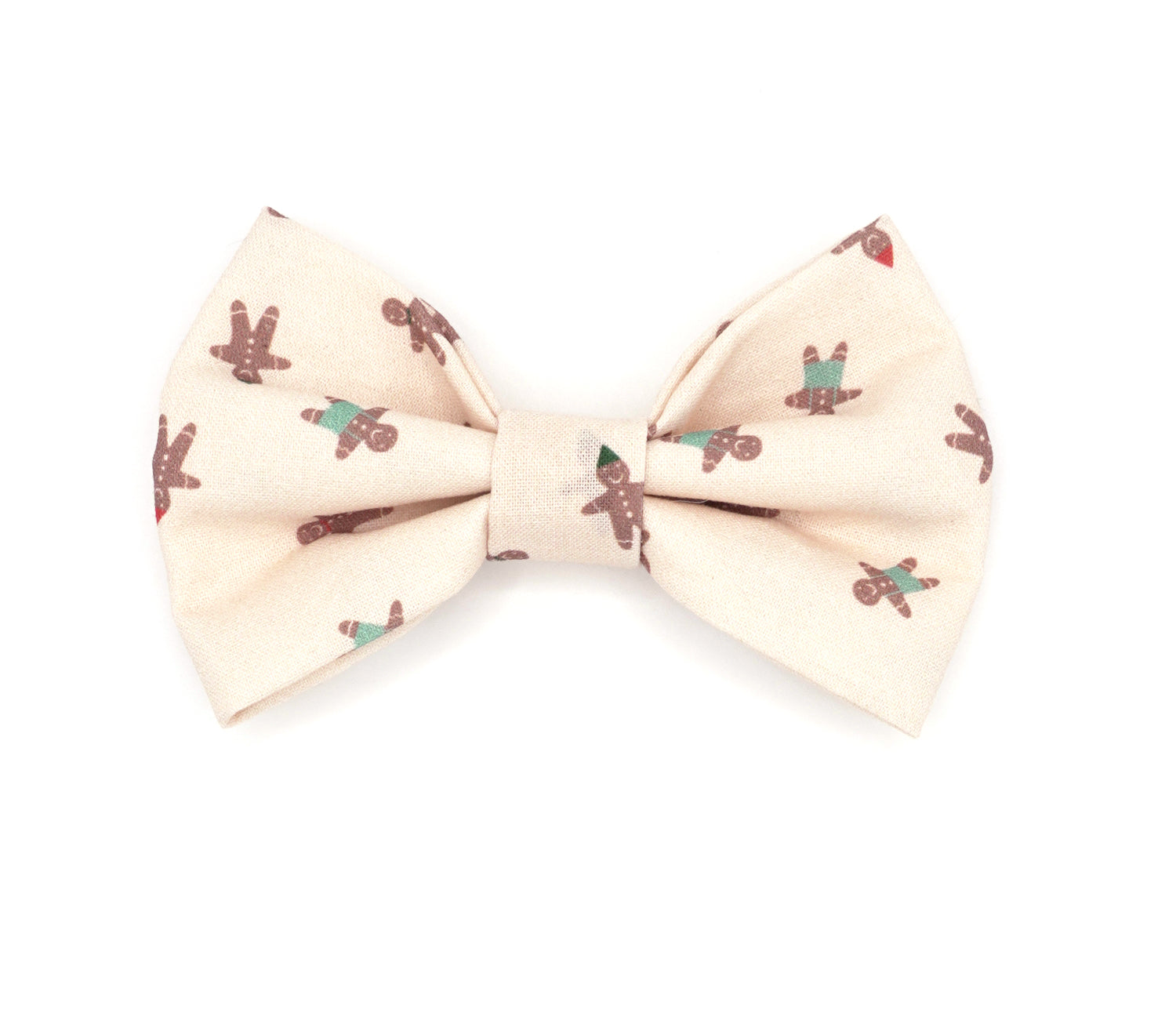 Handmade cotton bow tie for dogs (or other pets). Elastic straps on back with snaps make it easy to add to collar, harness, or leash. Very light beige background with brown gingerbread people, some wearing red or black party hats, some with teal pants.
