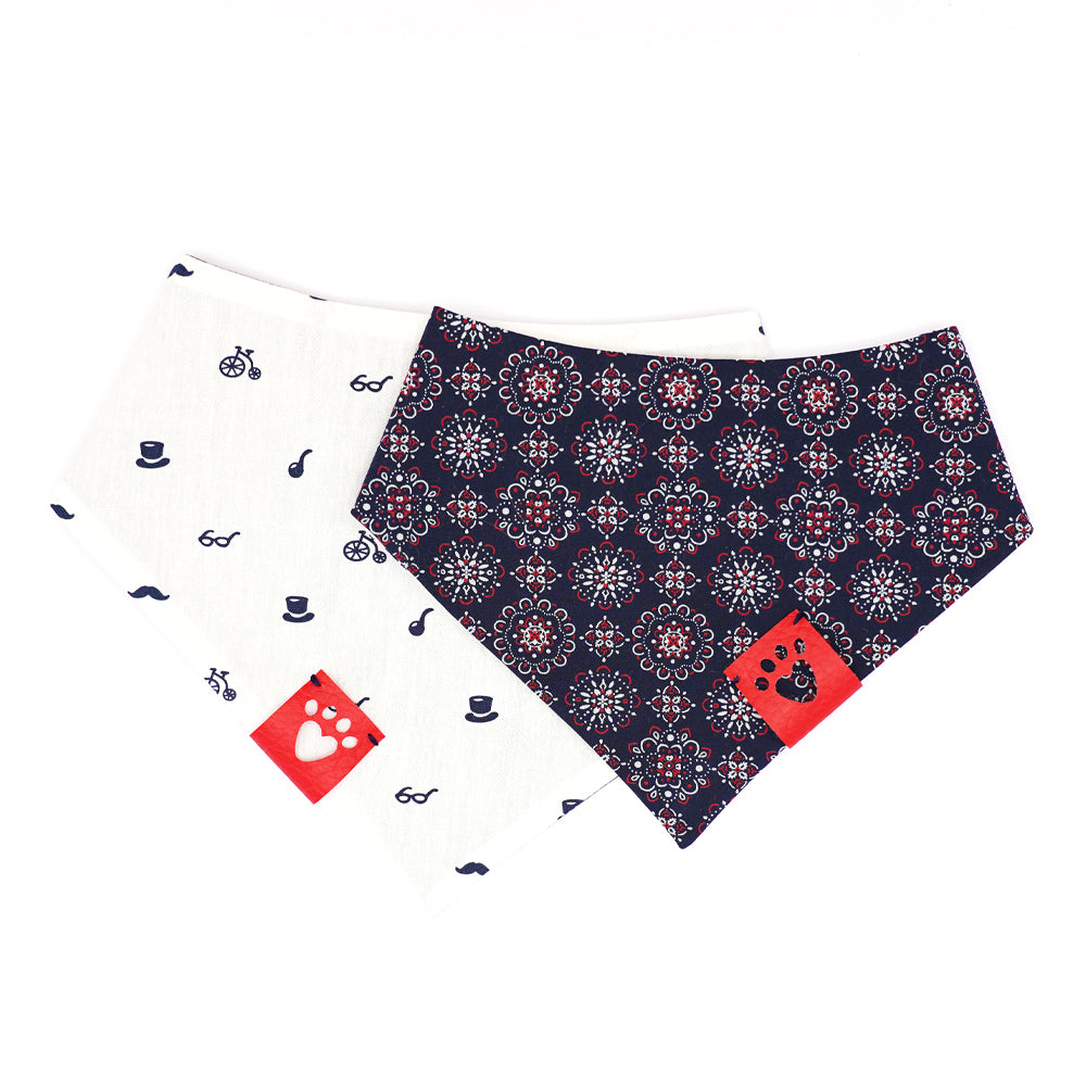 Reversible bandana for dogs. Snaps on back make it adjustable. One side is White background with navy blue glasses, top hats, pipes, mustaches and high wheeler bikes and the other side has a Navy blue background with red and white mandalas. Red tag with heart paw cut out on side.