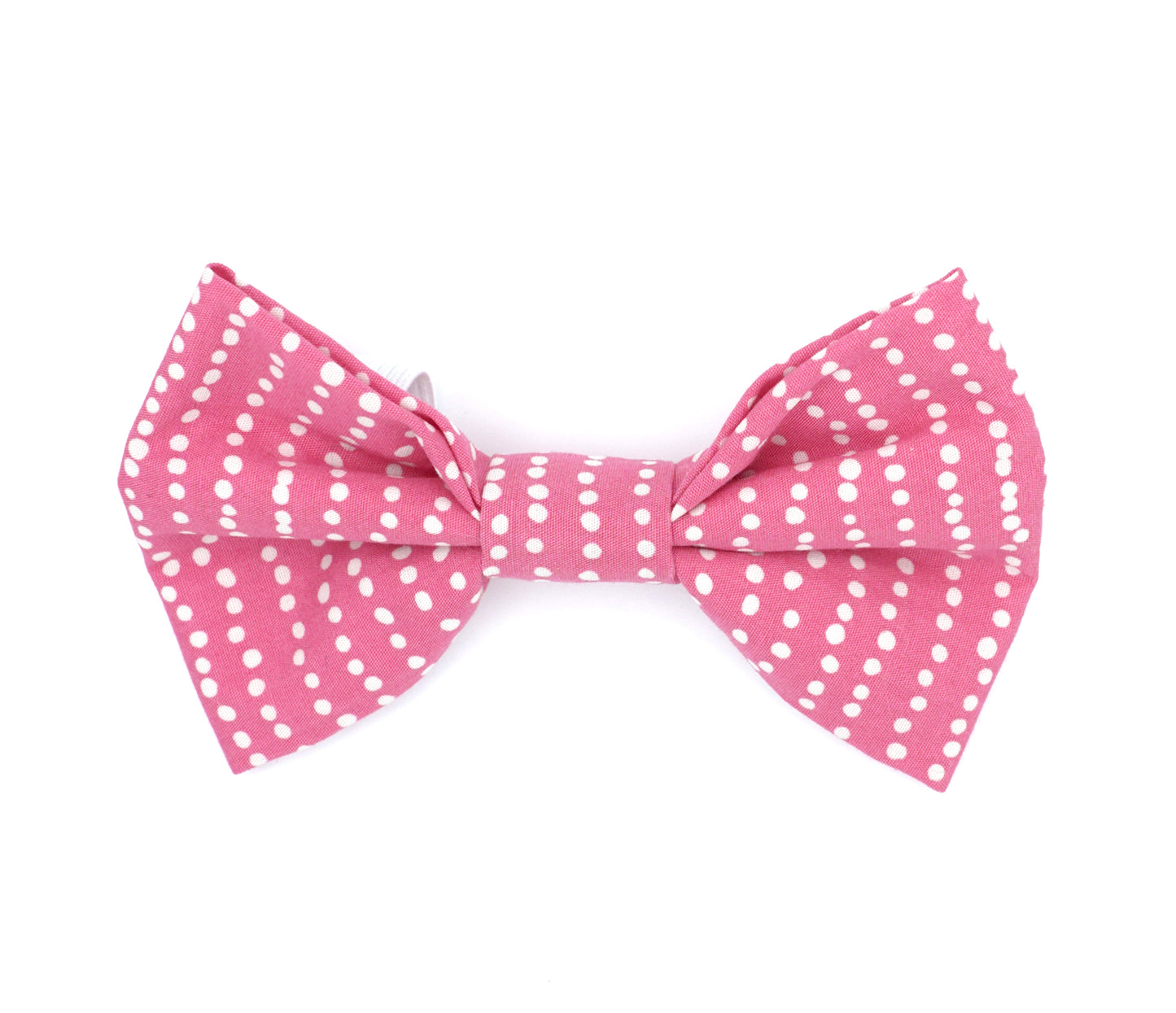 Handmade cotton bow tie for dogs (or other pets). Elastic straps on back with snaps make it easy to add to collar, harness, or leash. Hot pink background with "stripes" of irregular white dots.