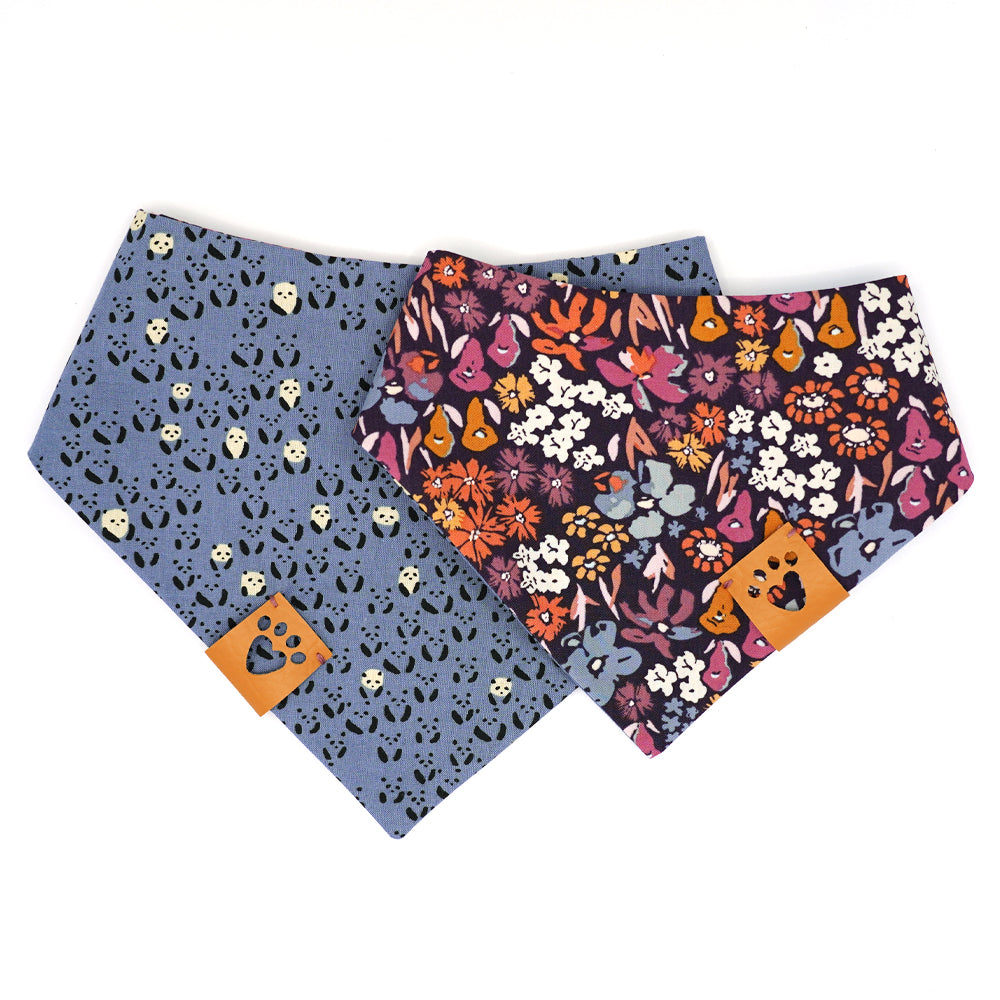 Reversible bandana for dogs. Snaps on back make it adjustable. One side is Periwinkle blue background with mini black and white  pandas and the other side has a Dark purple background with coral, pink, cream, gold, orange and periwinkle flowers. Tan tag with heart paw cut out on side.