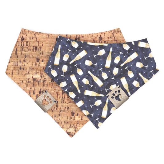 Reversible bandana for dogs. Snaps on back make it adjustable. One side is Navy blue background with white wine bottles and glasses and the other side has a Tan/brown cork pattern. Metallic Silver tag with heart paw cut out on side.