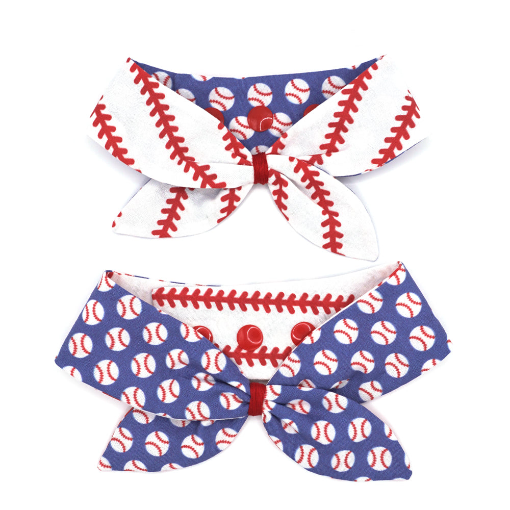 Reversible neckerchief for dogs. Snaps on back make it adjustable. One side White background with bright red baseball stitches and the other side has a Bright blue background with white baseballs with red stitches. Embroidery thread wrapped center in red.